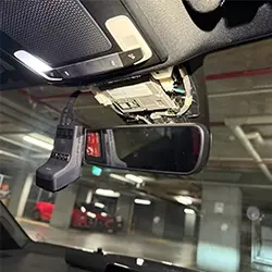 Seamless dashcam installation with wiring concealed behind vehicle interior panels