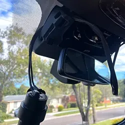 Safely routed and secured dashcam wiring behind interior trim for occupant safety